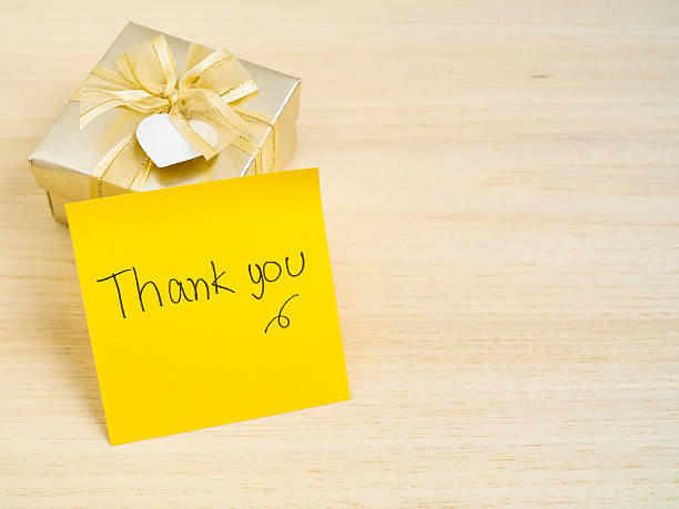 istock Thank you words on note on wood background 516210724