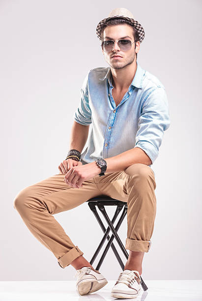 istock Fashion man sitting resting his hands on his leg 516210748