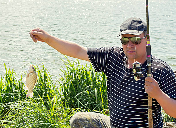istock The fisherman caught the carp 516211260