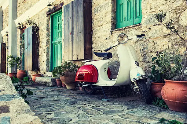 Photo of Old scooter parked by the wall
