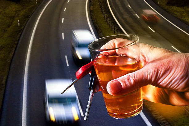 istock hard drinker with liqueur glass and going cars 516213162