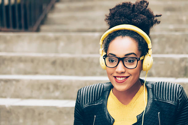 istock Young afro woman listening music 516213372