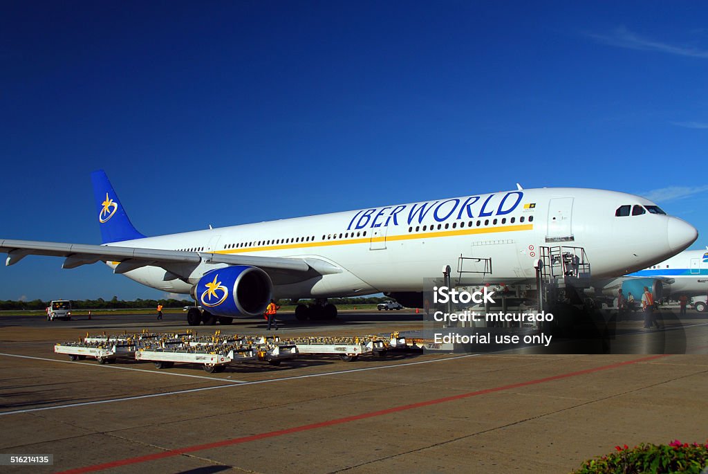 Punta Cana, Dominican Republic: Iberworld Airbus A330 Punta Cana, Dominican Republic - September 4, 2007: Iberworld Airbus A330-322 EC-IJH and dollies for containers and palettes - Punta Cana International Airport - PUJ / MDPC - photo by M.Torres Airbus A319 Stock Photo