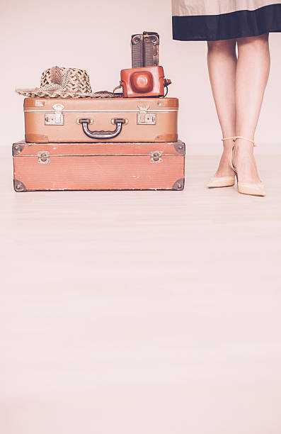 istock Woman standing beside suitcases 516214522