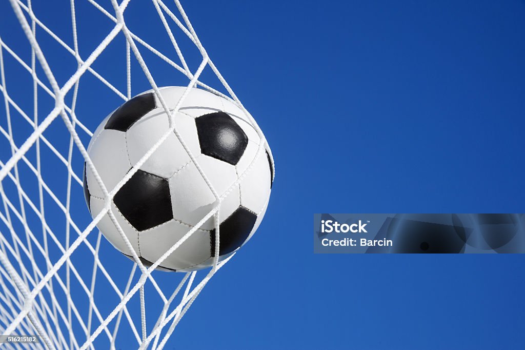 Goal Soccer ball in the goal net against blue sky background Soccer Stock Photo