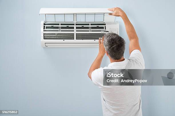 Man Cleaning Air Conditioning System Stock Photo - Download Image Now - Air Conditioner, Installing, Repairing