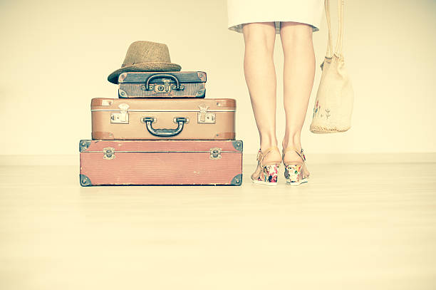 istock Woman is standing beside suitcases 516216012
