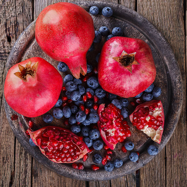 Juicy pomegranates,whole and broken and blueberries