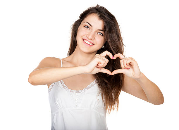 istock Beautiful girl shows a heart symbol 516219377