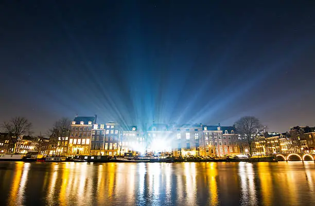 Lightshow over the river Amstel at the canals of Amsterdam, The Netherlands