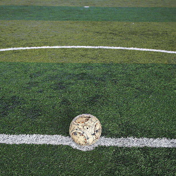 istock Old soccer ball on new Artificial turf 516220427