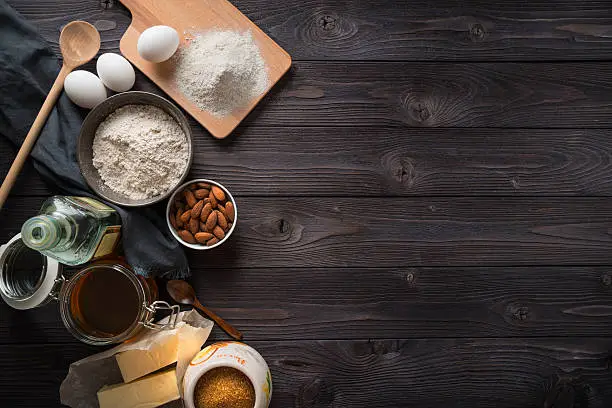 Photo of Ingredients for baking on a wooden background top view