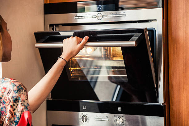 istock Woman preparing food on stove 516230577