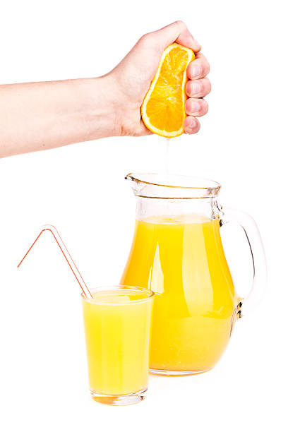 istock orange juice pouring into glass 516232893
