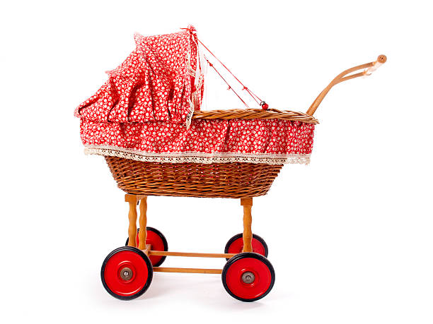 Old vintage childrens doll stroller over a white background stock photo