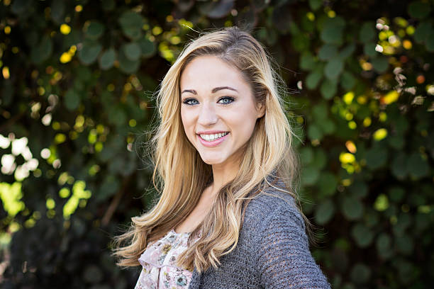 istock Beautiful Young Woman Against Leafy Green Backdrop 516233283