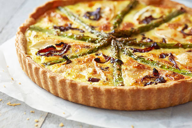 istock Asparagus quiche on white wooden surface 516233443