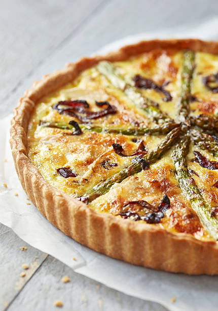 istock Asparagus quiche on white wooden surface 516233445