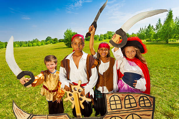 istock Happy pirate children and their captain with helm 516235983