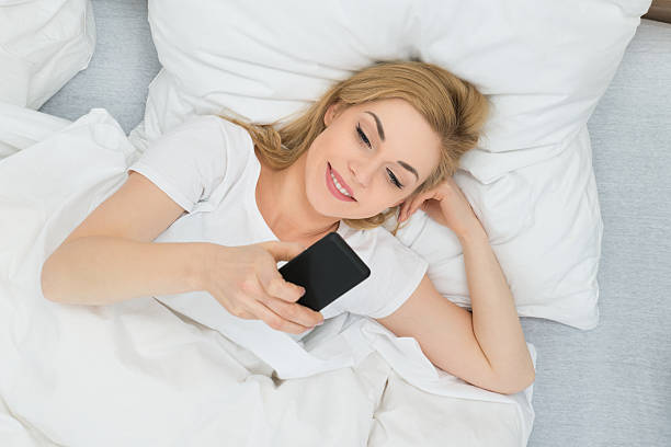 istock Woman With Mobile Phone In Bed 516237162