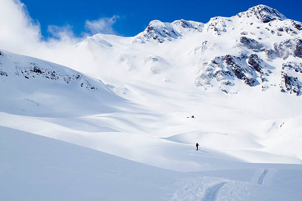 istock skier going up of a mountain to the mist 516237934