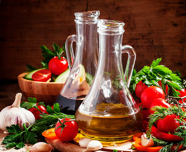 istock Olive oil and balsamic vinegar in pitchers, vegetables 516239224