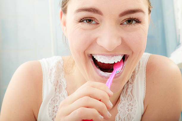 istock Woman brushing cleaning teeth. Oral hygiene. 516243644