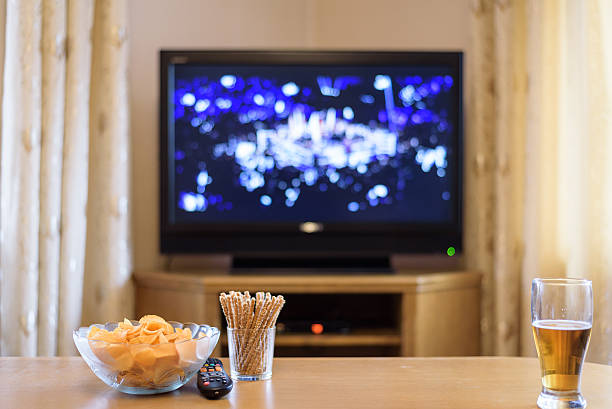 istock Television, TV watching (boxing match) eating snacks and drinking alcohol 516245432