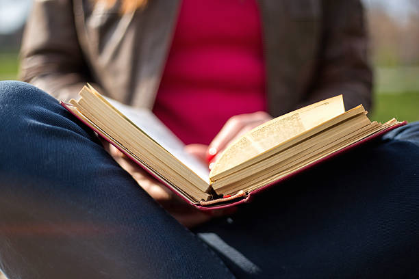 istock Cute young woman reading the book 516246136