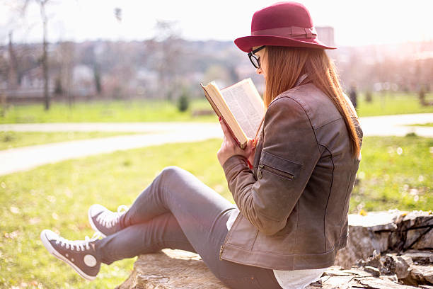 istock Cute young woman reading the book 516246312