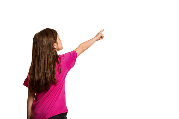 istock Cute little girl pointing with finger 516247977