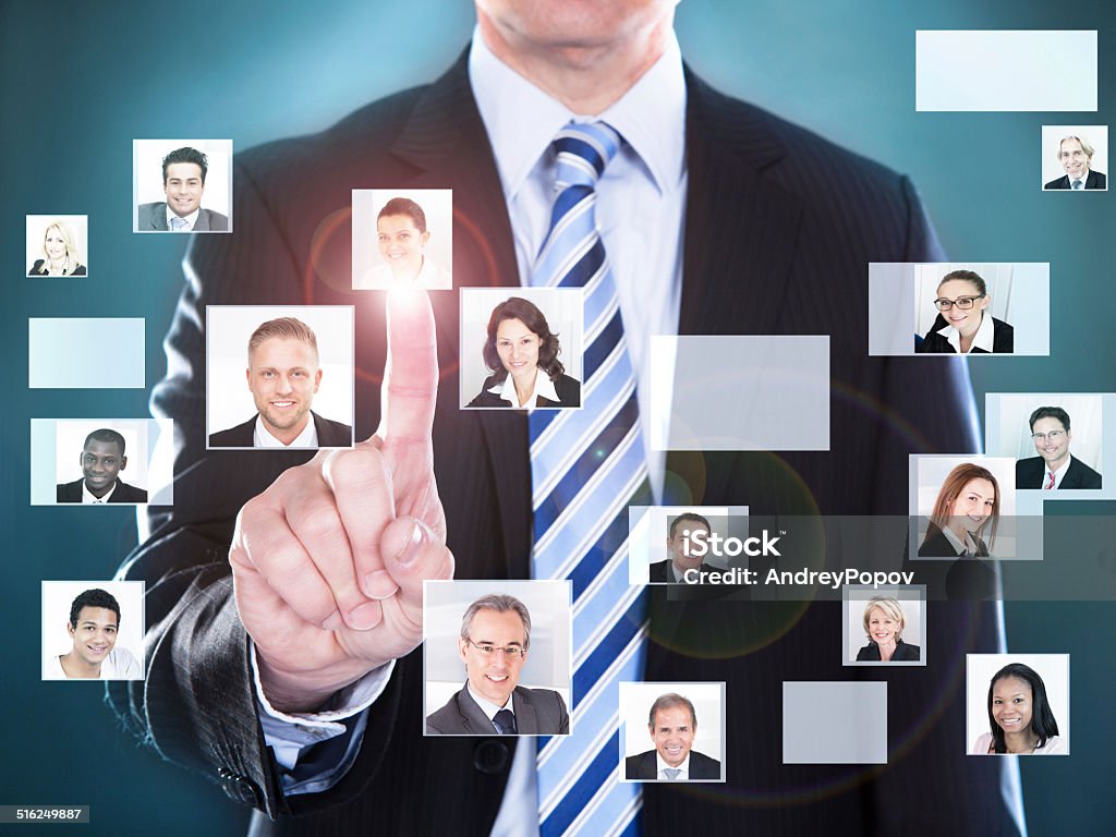 Businessman Choosing The Perfect Candidate For The Job Midsection of businessman choosing the perfect candidate for the job Adult Stock Photo