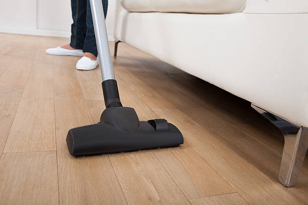 istock Low Section Of Woman Vacuuming Floor 516250147