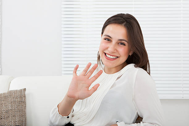 istock Happy Businesswoman Waving Hand On Sofa 516250171