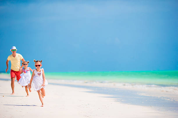istock Young family enjoying beach summer vacation 516250942