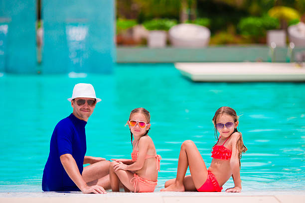 istock Happy family in swimming pool 516251130