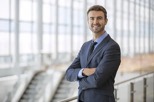 Photo of Portrait of happy businessman inside an airport terminal