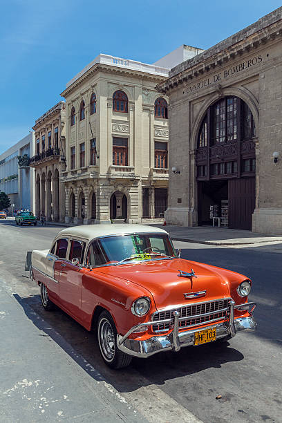 Havana, Cuba - April 1, 2012: Orange Chevrolet vintage car in front of Museo de los Bomberos