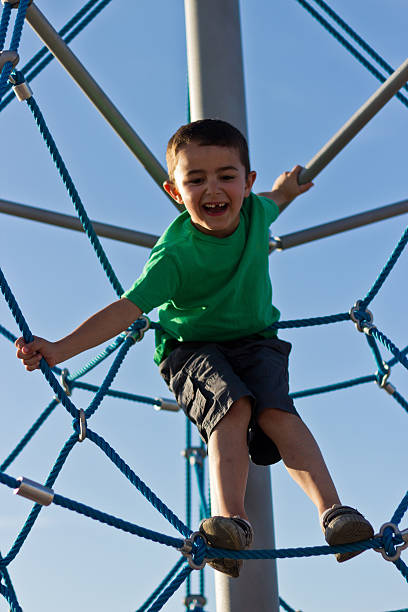 istock Kid having fun on the jungle gym at playground 516251639