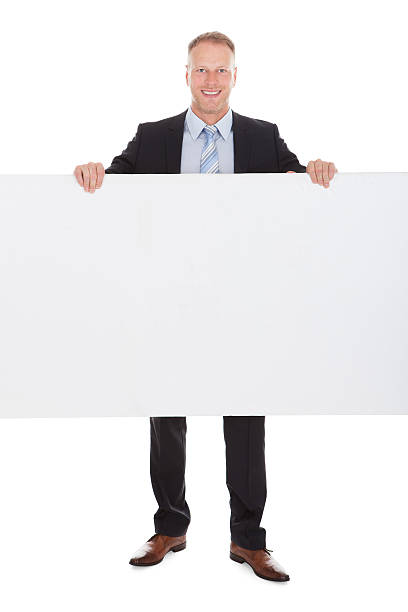 istock Confident Businessman Showing Billboard 516252583