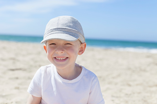 little smiling boy enjoying summer time at the beach