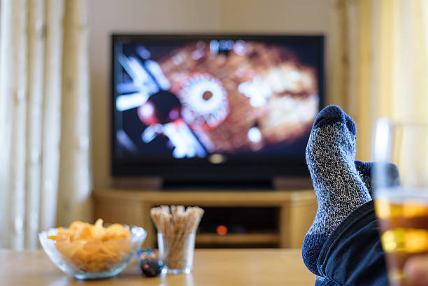 istock Television, TV watching (basketball game) with feet on table 516253654