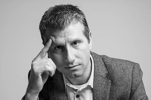 istock pensive attractive businessman portrait looking at camera 516254072
