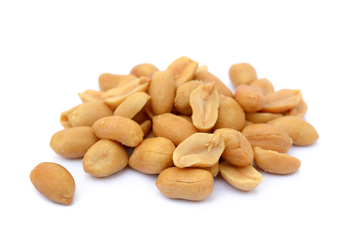 Arranged peanuts peeled and isolated on white background