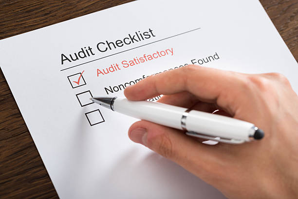 istock Person Filling Audit Checklist Form At Desk 516255502