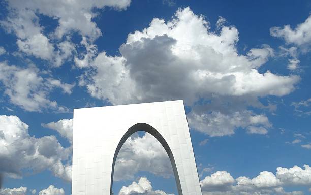 istock Shiny arch in front of fluffy white clouds 516256752