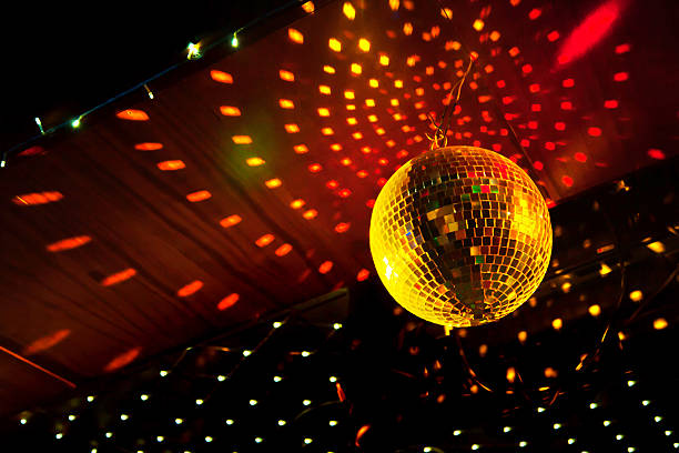 Mirror disco ball with light reflection on the ceiling Mirror disco ball with light reflection on the ceiling, on a black background nightclub stock pictures, royalty-free photos & images