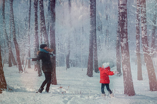 istock Children play in snowy forest. 516262472