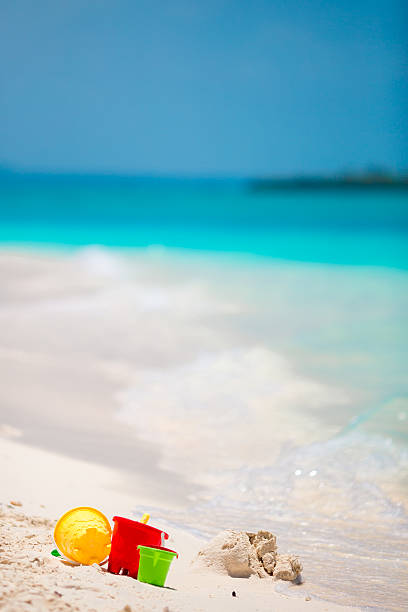istock Summer kid's beach toys in white sandy beach 516262488