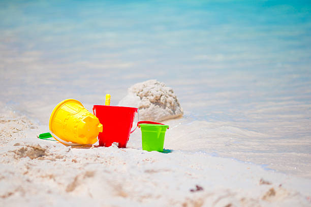 istock Kid's beach toys on white sandy beach 516262828